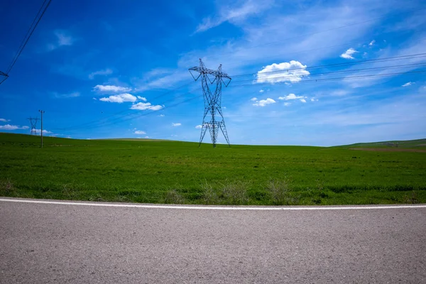Green Wheat field, Blue sky and high voltage line