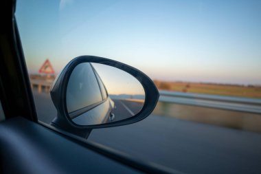 Aracın yan aynasından yol görünümü