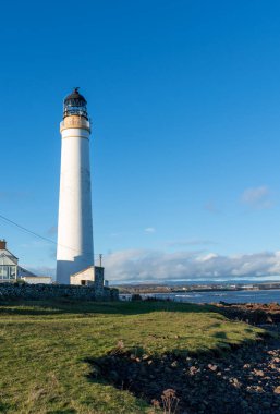 Lighthouse on the coast of the North Sea in Scotland against a dramatic sky