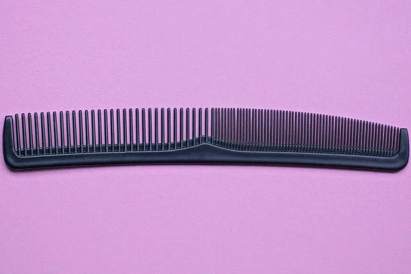 One Long Black Plastic Comb Lies Pink Table — Stock Photo, Image