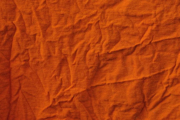 Helder Oranje Stof Achtergrond Van Een Stuk Van Verkreukelde Kleding — Stockfoto