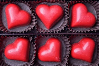 set of red candy heart in a brown paper box 