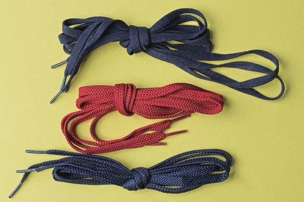 Three Skeins Red Blue Laces Lie Yellow Table — Stock Photo, Image