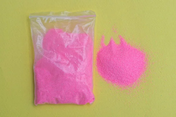 Одна Маленька Пластикова Сумка Рожевим Піском Жовтому Столі — стокове фото