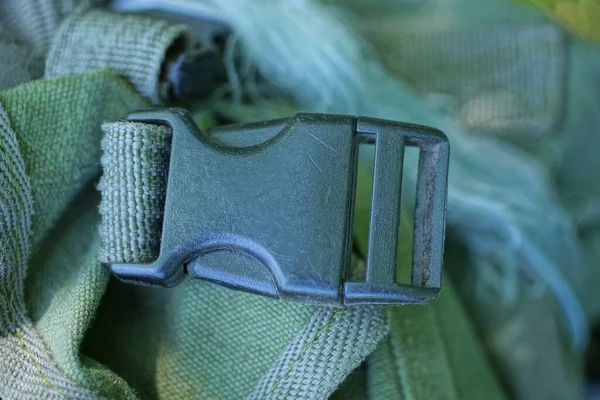 stock image one closed black carbine latch on the harness on the green matter