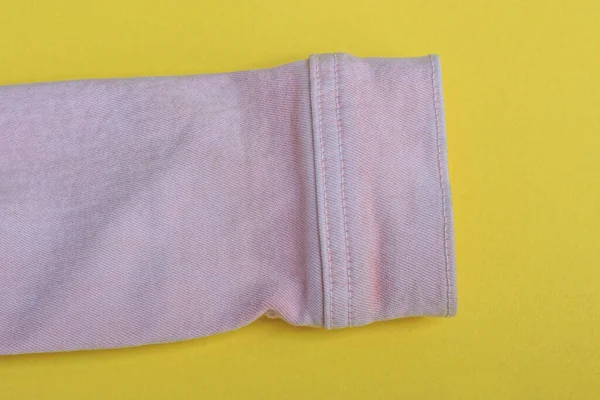Egy Rózsaszín Kabát Szatén Szövetből Egy Sárga Asztalon Fekszik — Stock Fotó