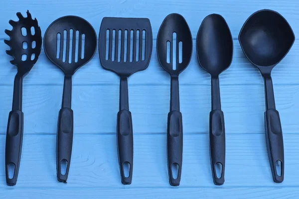 Kitchen utensils background with copyspace, home kitchen decor concept,  black kitchen tools, rubber accessories in container.Restaurant, cooking,  culinary, kitchen theme. Silicone spatulas and brushes Stock Photo