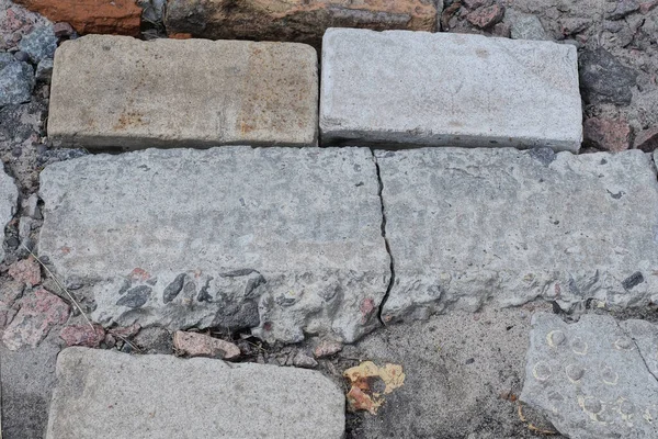 stock image texture of white gray pieces of stones with cracks on the earth on the street