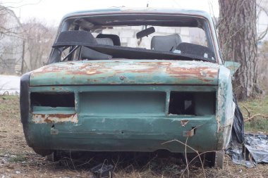 Eski parçalanmış bir yolcu vagonunun arkası. Sokakta yeşil siyah bir sandıktan.