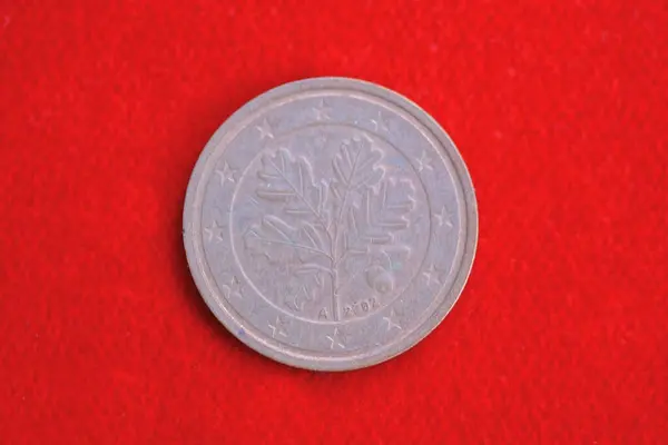 Stock image one brown coin ten euro cents lies on the red table