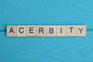 word acerbity made from wooden gray letters lies on a blue background clipart