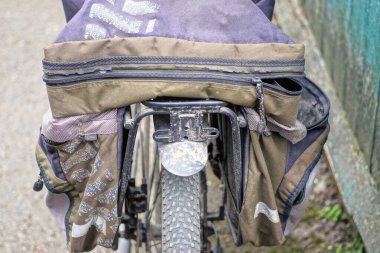 Boş bir siyah sırt çantası sokakta bir bisiklet bagajında yatıyor.