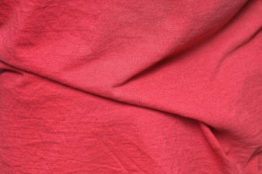 Eski kıyafetlerdeki buruşuk kumaş parçasının kırmızı dokusu.