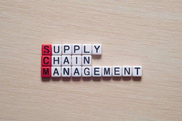 Supply chain management - word concept on cubes, text, letters