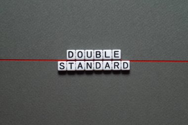 Double standard - word concept on cubes, text, letters clipart