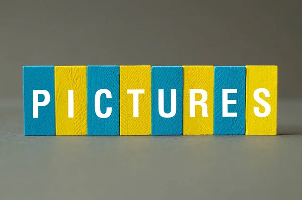 Pictures - word concept on building blocks,text