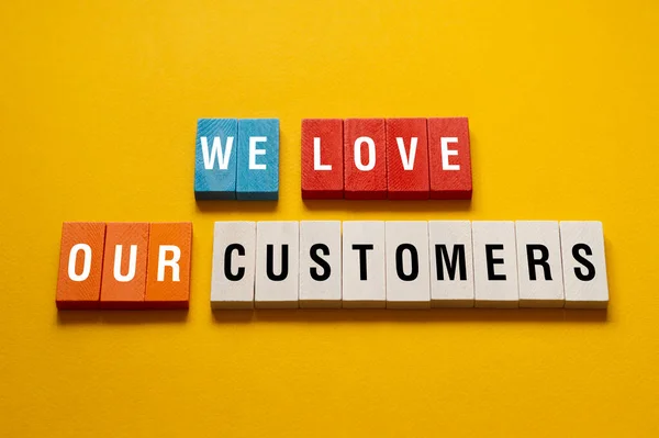 stock image We Love our customers - word concept, text,letters