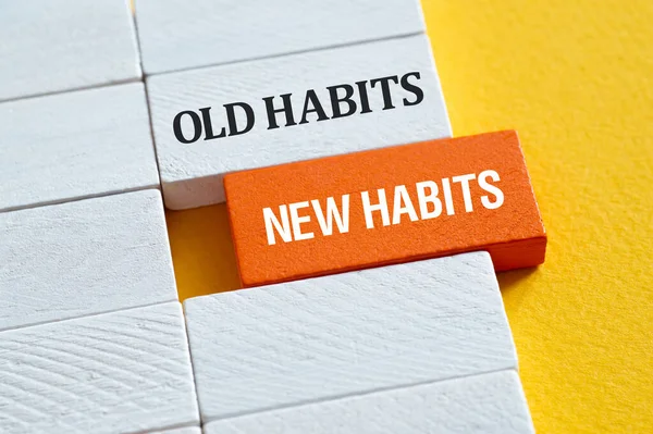 Old Habits , New habits - word concept on building blocks, text, letters