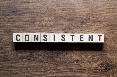 Consistent - word concept on building blocks, text, letters clipart