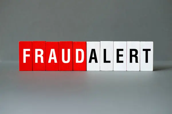 Fraud alert - word concept on building blocks, text, letters