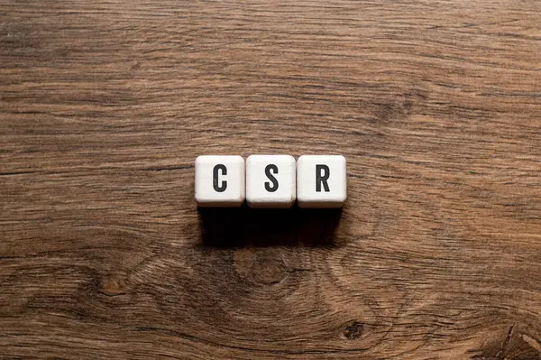 CSR - Corporate social responsibility - word concept on building blocks, text, letters