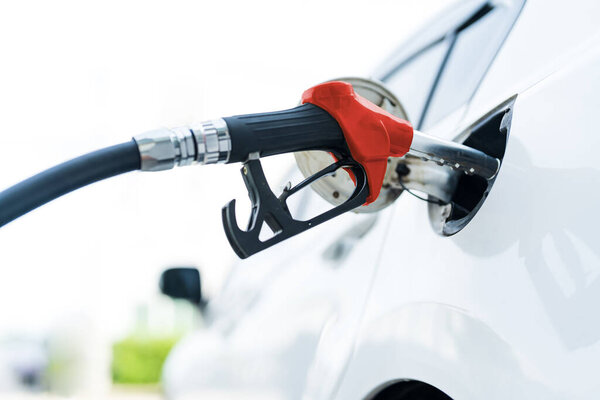 Man hand filling and pumping gasoline oil the car with fuel at station, Filling car with gas fuel at station pump