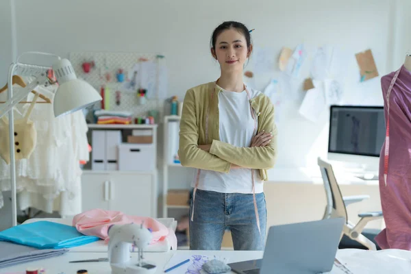 fashion designer woman Happy to design clothes at work.
