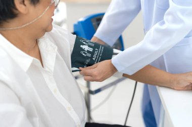 Elderly woman checking blood pressure To check the health of the body by the doctor for advice.