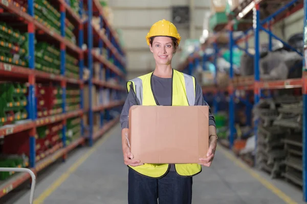 stock image A female worker sorting goods in a warehouse in order to be delivered to customers