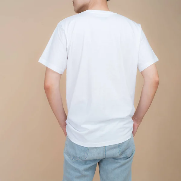 Male Fashion Model White Shirt Jeans Standing Studio Beige Background — Stock Photo, Image