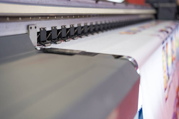 Close-up of large format printer heads in action, Detailed view of modern large format printer heads working on white media