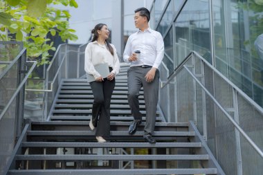 Dışarıdan inerken sohbet eden iki profesyonel.