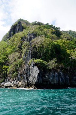 El Nido Takımadası 'ndaki mavi denizde devasa kireçtaşı kayaları.
