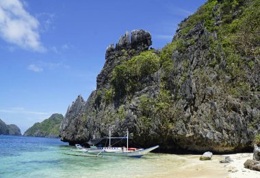 El Nido Takımadası 'ndaki mavi denizde devasa kireçtaşı kayaları.