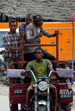 Paje, Zanzibar - October 2024: group of men on a local taxi clipart