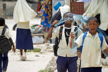 Paje, Zanzibar - October 2024: group of children leaving the school  clipart