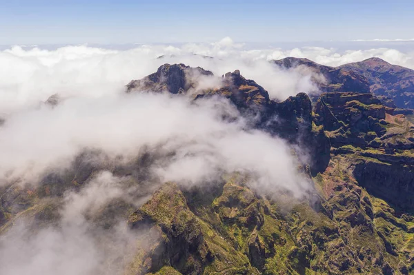 stock image Drone view of mountain peak submerged in fog during summer day