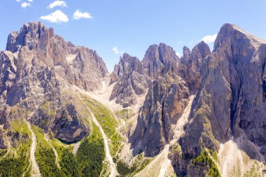 Drone photography of dolomite mountain peaks during summer day.