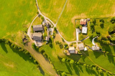 Drone photography of small mountain farm during summer day
