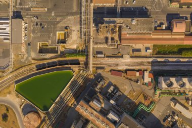 Drone photography of big chemical factory, pipes and railway during summer day