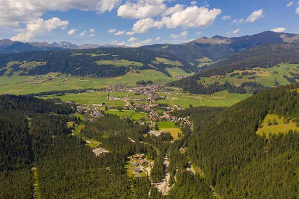 Drone photography of small mountain town in valley during summer day