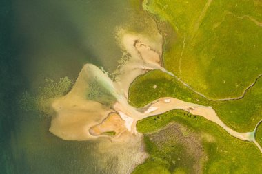 Drone photography of drone flowing into lake during summer day