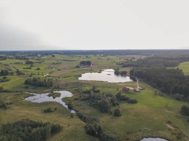 Drone photography of agriculture fields, lake and rural landscape during summer day
