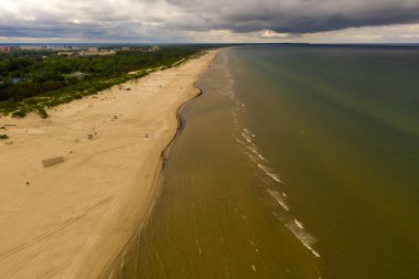 Drone photography of beach seaside and town during summer cloudy day