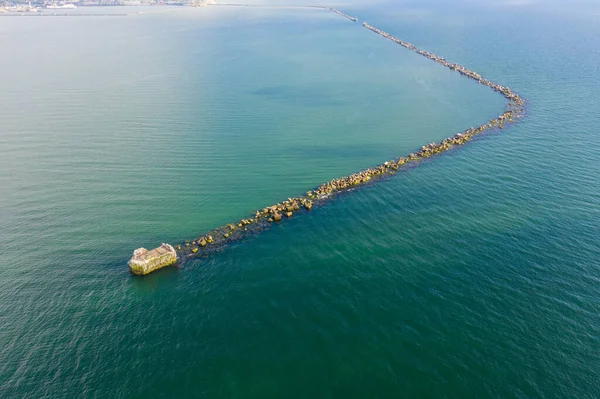 Drone photography old seawall and sea during summer day