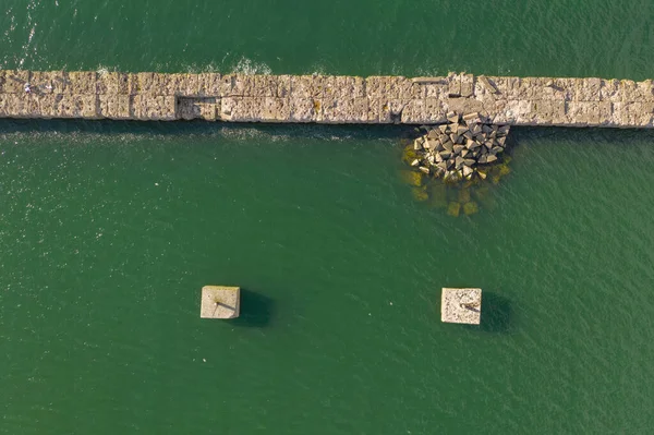 Drone photography old seawall and sea during summer day