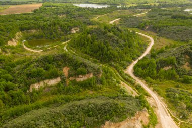 Drone photography of old abandoned quarry and nature taking it back during summer day