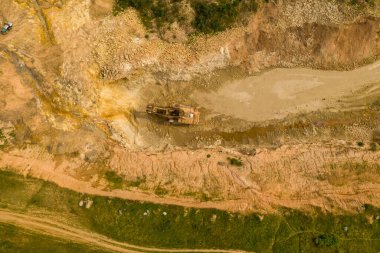 Drone photography of old abandoned excavator in quarry during summer day
