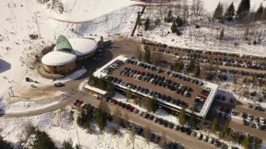 Drone video of ski resort in mountains and parking place