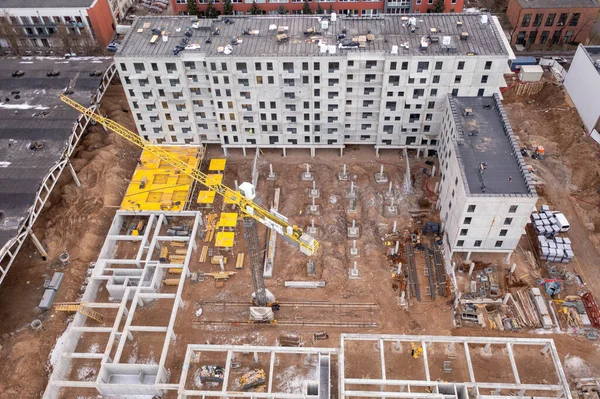 Drone photography of apartment construction site during spring morning. High angle view